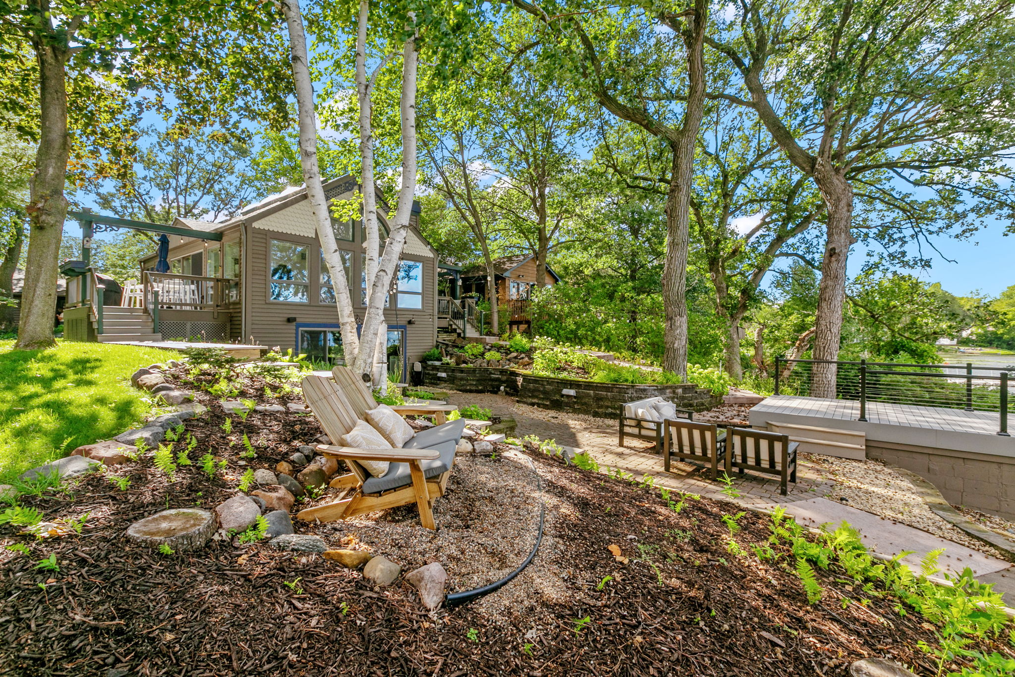 A charming lakeside property with a welcoming outdoor area and lush greenery.