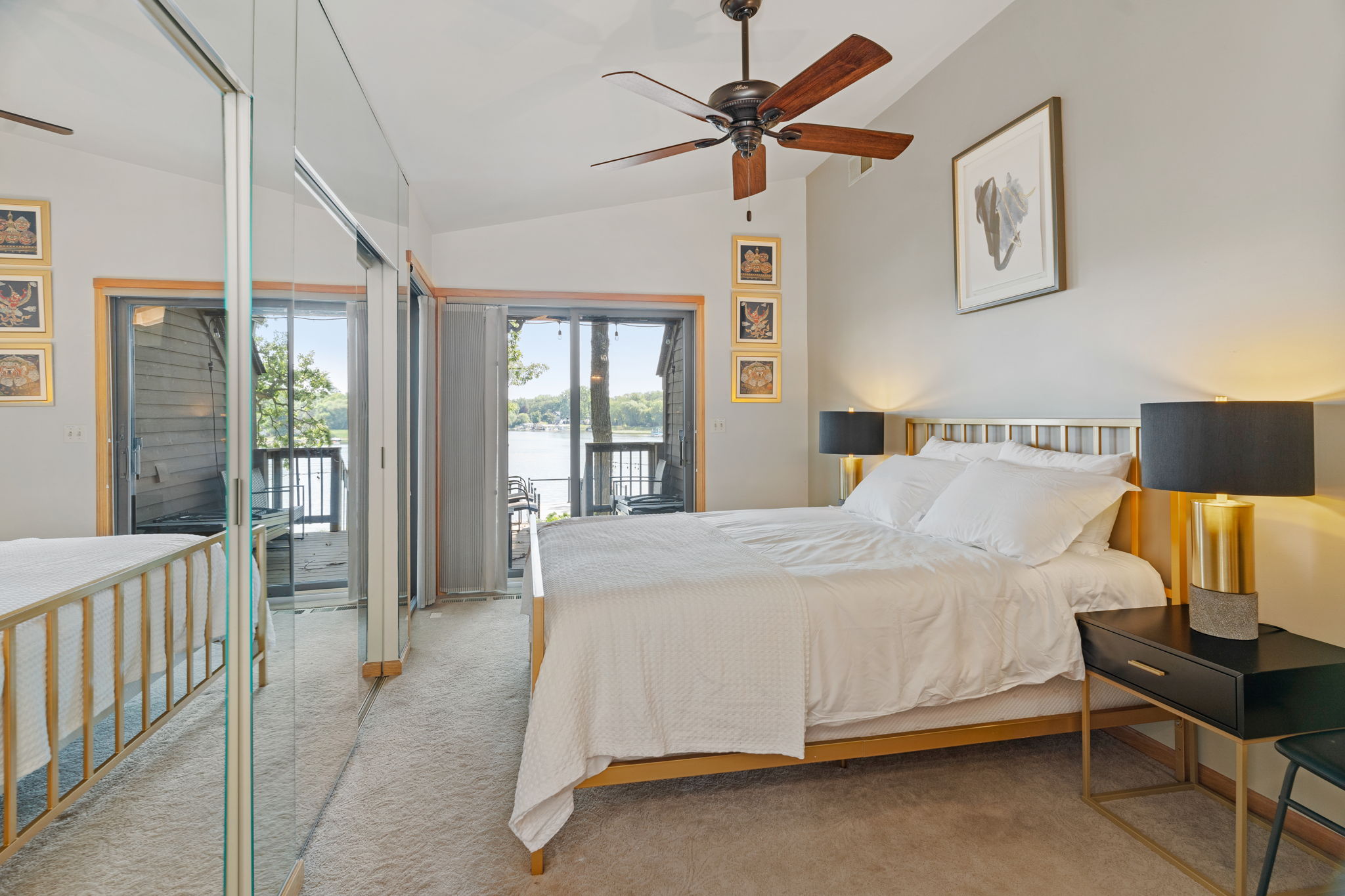 A modern lakeview bedroom with stylish decor and serene ambiance.