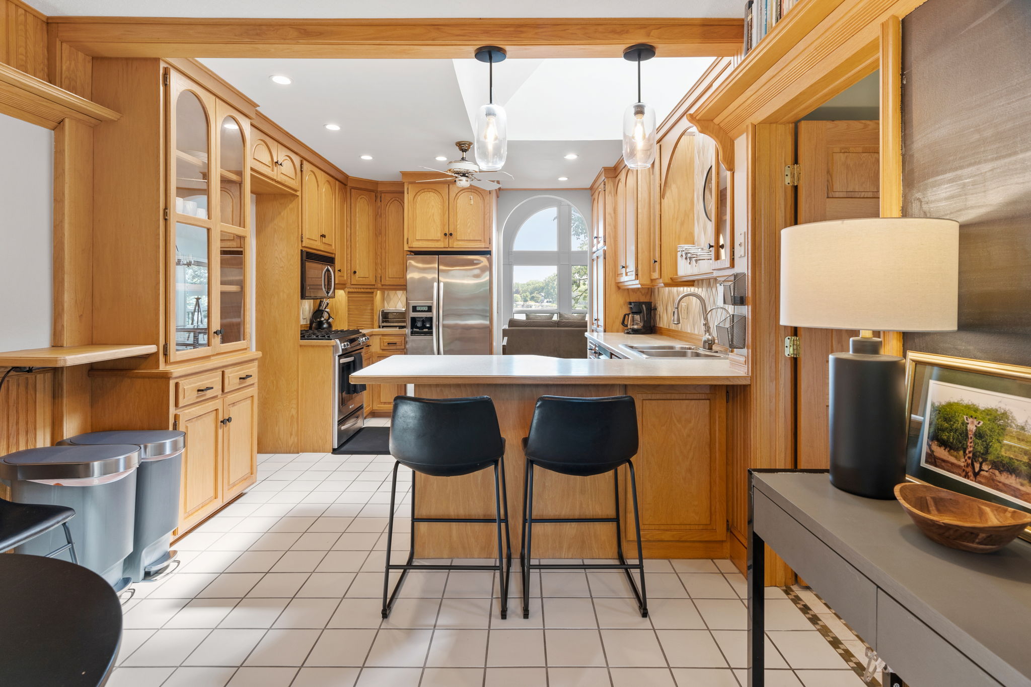 Bright and warm kitchen featuring wooden cabinetry and modern appliances.
