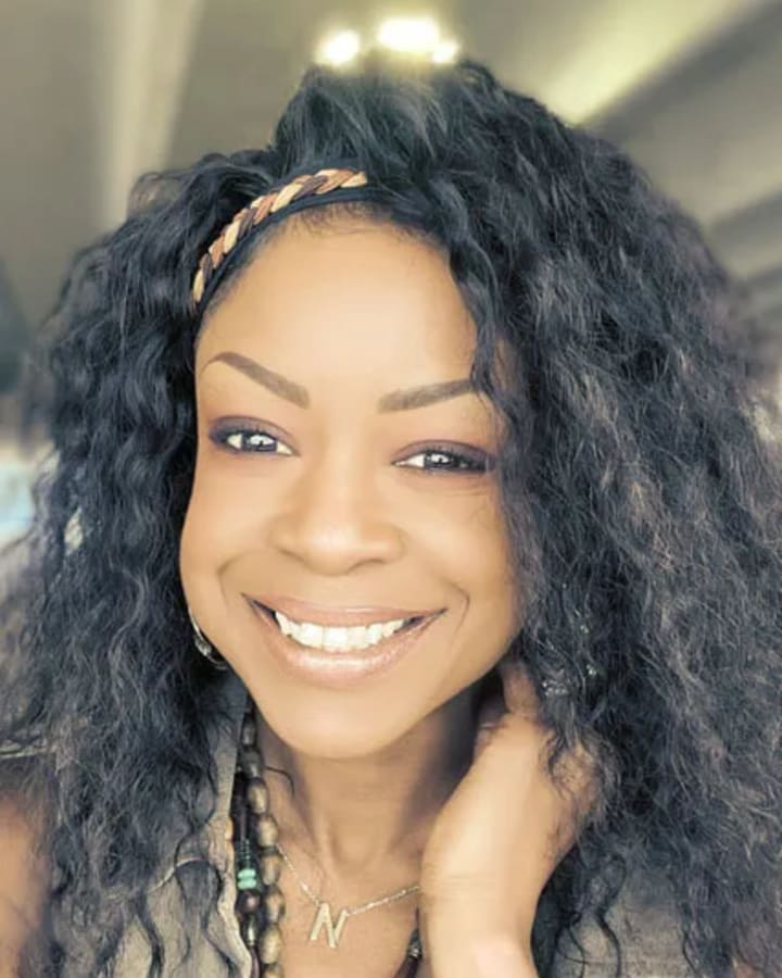 Nia Berry, Client Care Coordinator, smiling