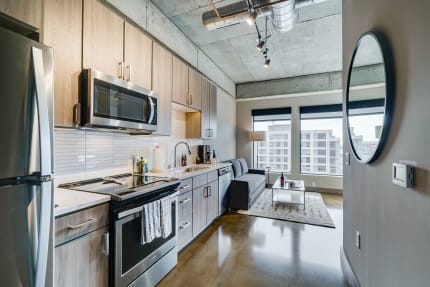 Modern kitchen and living area in urban apartment.