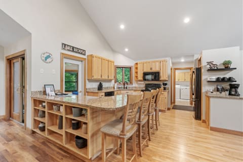 Interior view of a cozy kitchen with wood cabinetry and modern appliances.