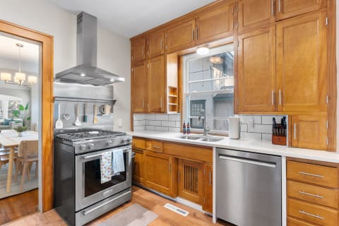 Warm wooden kitchen with stainless steel appliances and a spacious countertop.