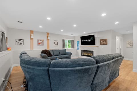 Cozy modern living room featuring a blue sectional sofa and contemporary fireplace.