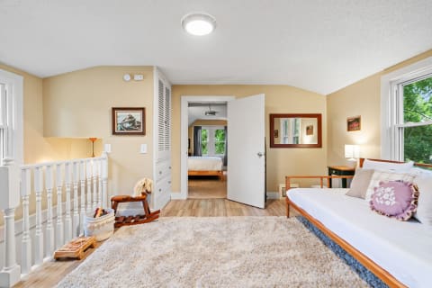 Inviting interior of a room with a daybed, soft rug, and decorative elements.