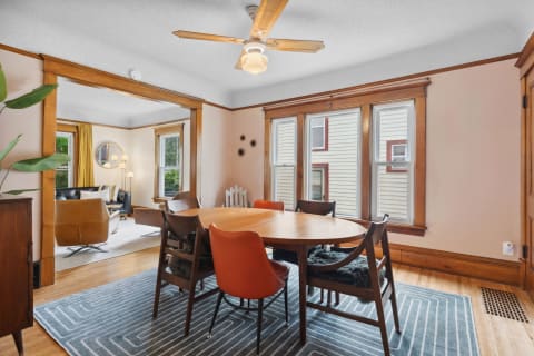 A well-furnished dining area with wooden accents and contemporary decor.