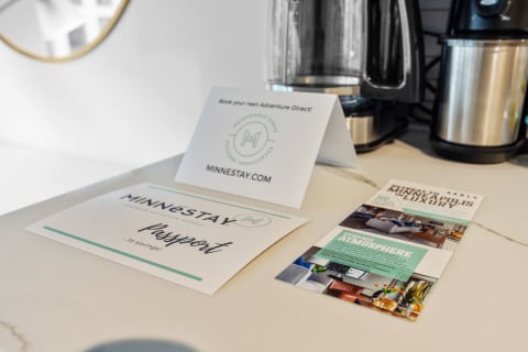 Minnestay promotional materials including a tent card and brochure on a countertop.