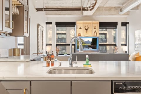 Modern kitchen with marble countertop and stylish accessories.