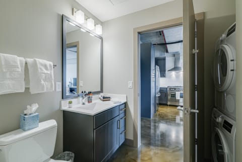 Interior view of a modern bathroom and kitchen area.