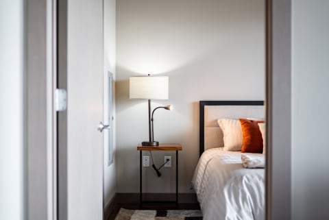Modern bedroom with bedside lamp and decorative pillows