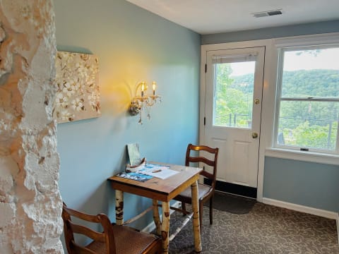 Cozy work nook featuring a rustic table with chairs and a mountain view.