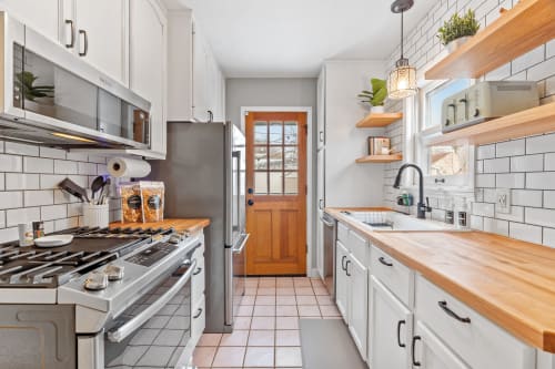 A bright and modern kitchen with a sleek design and wooden accents.