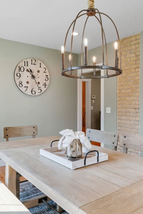 Stylish and inviting dining area featuring rustic furniture and modern lighting.