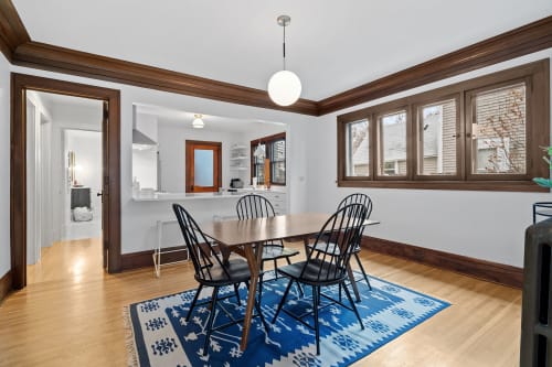A stylish dining area showcasing modern design and warm wood accents.