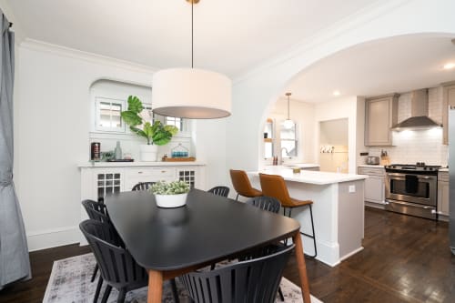 Modern dining area connected to a contemporary kitchen.