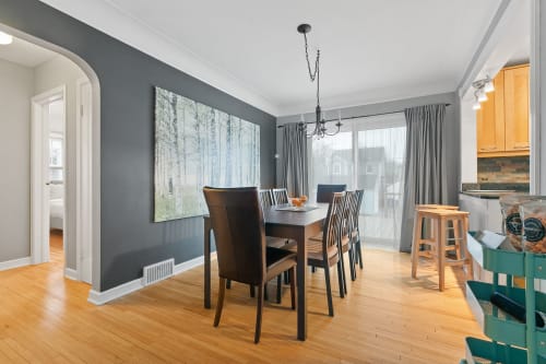 Chic dining area featuring modern decor and ample natural light.