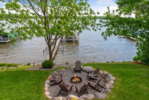 A cozy fire pit by the lake, perfect for summer gatherings.