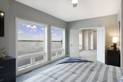 A modern bedroom with stunning lake views.