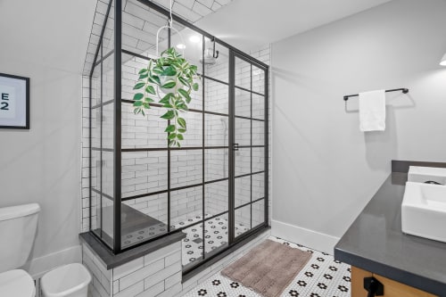 A stylish modern bathroom featuring a glass shower and elegant design elements.
