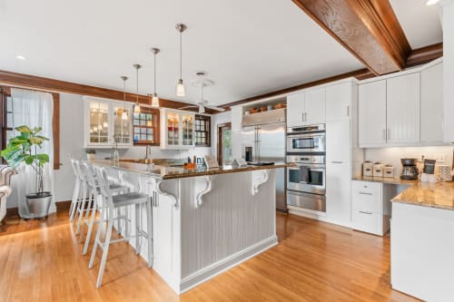 A modern kitchen with an elegant island and stylish appliances.