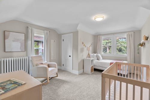 A serene and cozy nursery filled with soft tones and warm natural light.