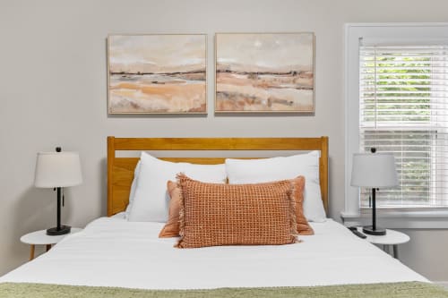 A cozy bedroom with earthy tones and modern decor.