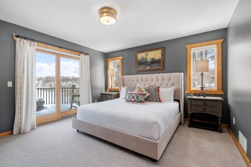 A cozy and inviting bedroom with modern decor and a beautiful view.