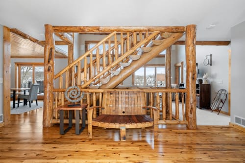 A charming interior featuring a rustic staircase and cozy seating area.