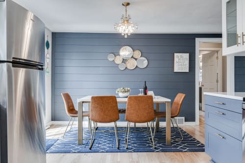 A modern kitchen dining area with a stylish table and warm decor.