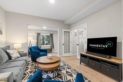 A modern living room featuring stylish furnishings and ample natural light.