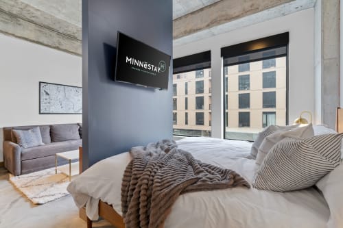 A stylish and modern studio apartment with cozy decor and urban views.