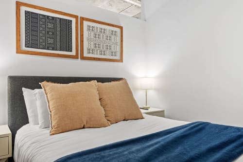 A cozy bedroom with stylish decor and warm colors.