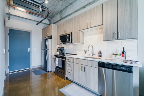 A stylish modern kitchen with industrial elements and polished finishes.