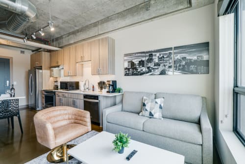 Modern urban living space with kitchen and living area.