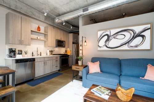 A cozy and modern living space with an open kitchen and stylish furnishings.
