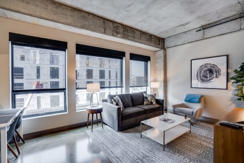 Modern living area with industrial decor and cozy furnishings.