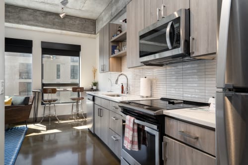 A contemporary kitchen showcasing modern design with stainless steel appliances and wooden accents.