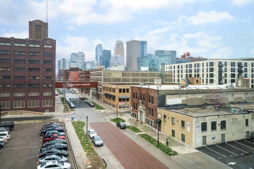 Urban landscape featuring a blend of historic and modern buildings with a city skyline in the background.