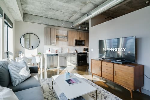 A stylish modern studio apartment with industrial design elements.