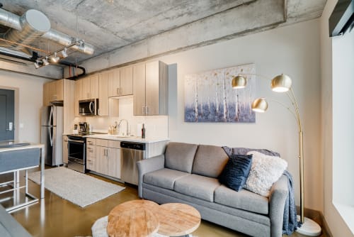 Modern living space with stylish kitchen and cozy seating area.