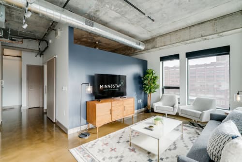 A modern urban living room with industrial decor and natural light.