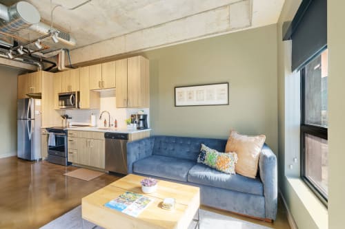 A modern apartment interior featuring an open kitchen and cozy living space.