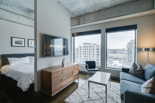 Stylish modern studio apartment with a cozy living area and urban views.