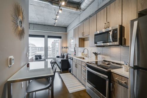 A contemporary kitchen and dining area in a stylish apartment.