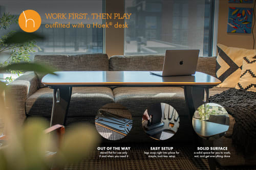 A modern workspace featuring a Hoek desk and a cozy couch, showcasing a blend of comfort and productivity.