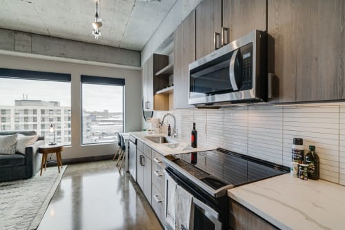 Modern urban kitchen with city skyline views and sleek design.