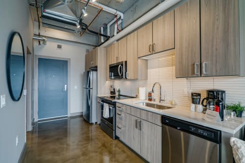 A modern kitchen with sleek design and stainless steel appliances.