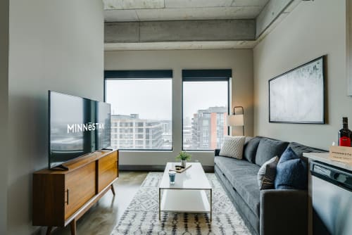 Modern urban living room with stylish decor and city views.