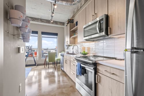 A stylish modern kitchen with city views and sleek finishes.