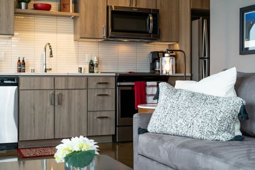A modern kitchen and living area featuring stylish finishes and cozy accents.